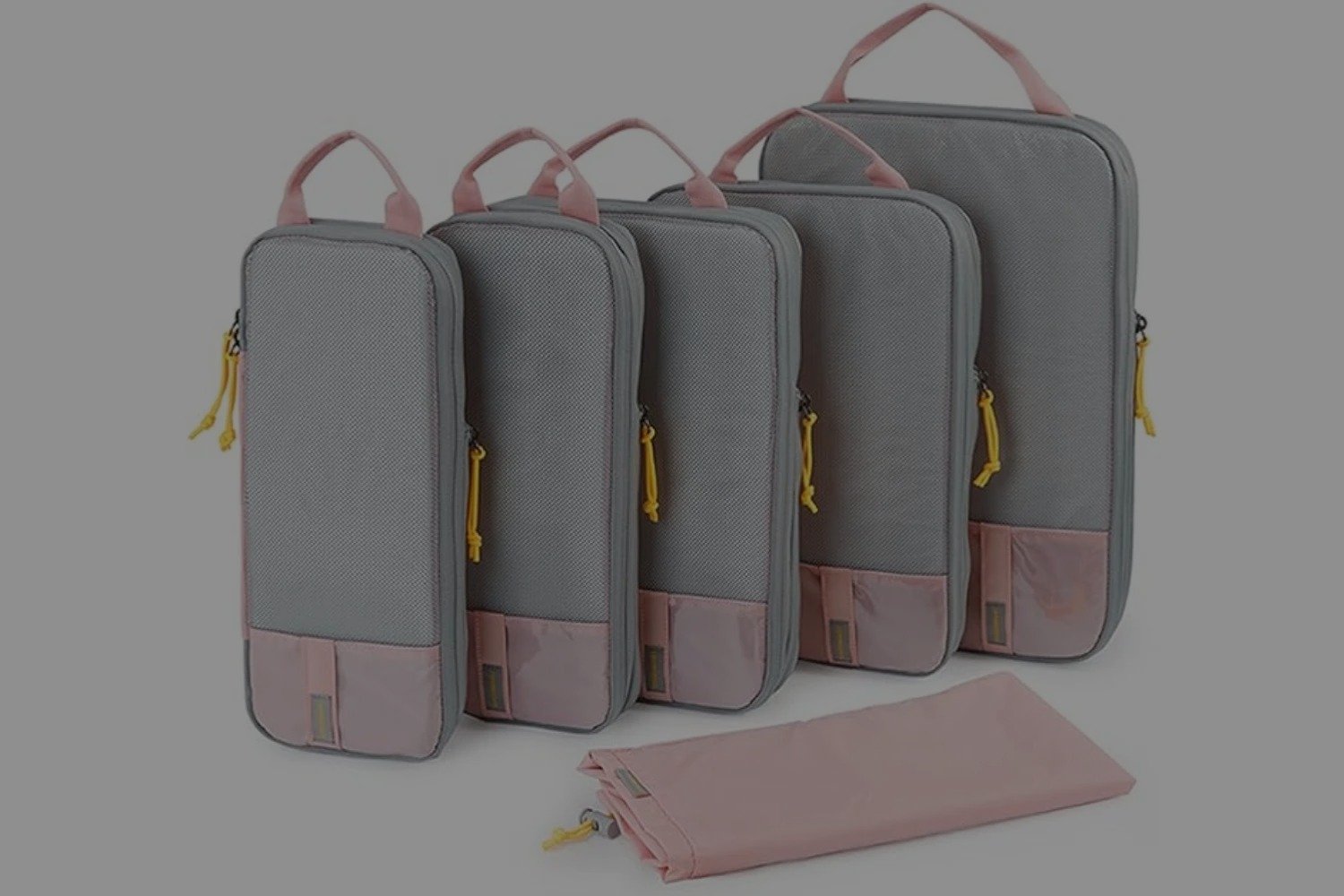 A set of organizer bags neatly arranged on a surface. The set includes various sizes of zippered pouches, each in matching colors and designs. The bags are designed to efficiently store and organize clothes and accessories for travel or home use, helping to keep items tidy and easy to access.